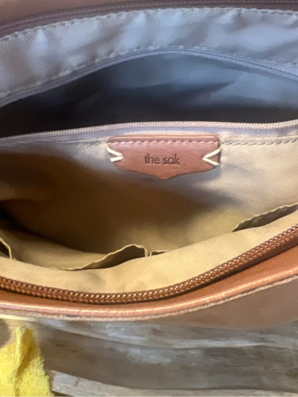 The Sak tan leather crossbody with beige interior